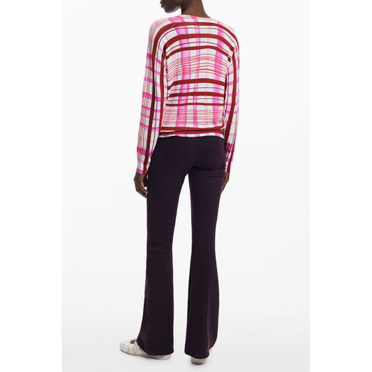 Pink and white striped knit women's sweater with long sleeves worn with dark trousers