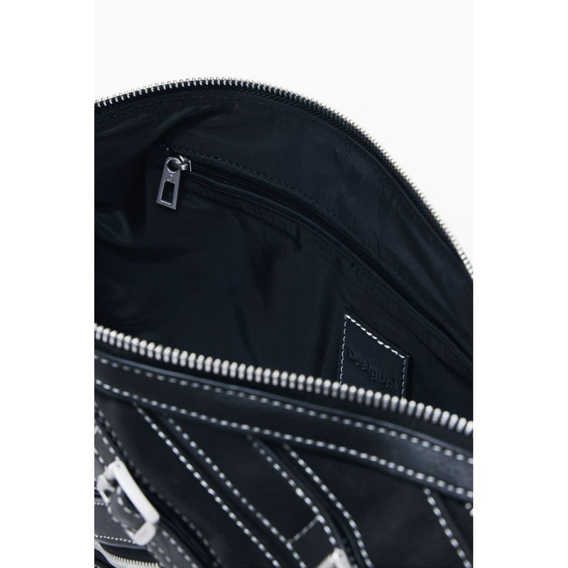 Open black polyurethane Desigual women's shoulder bag showing the lined interior and zipper pocket