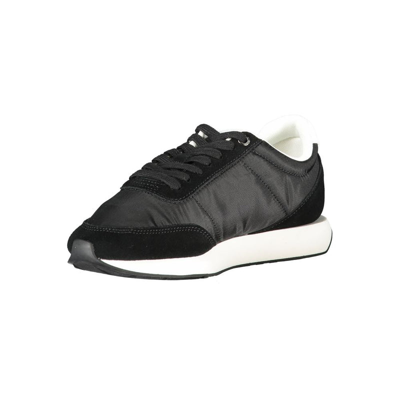 Calvin Klein black polyester women's sneaker with suede overlays and a white rubber sole in a sporty, casual style.