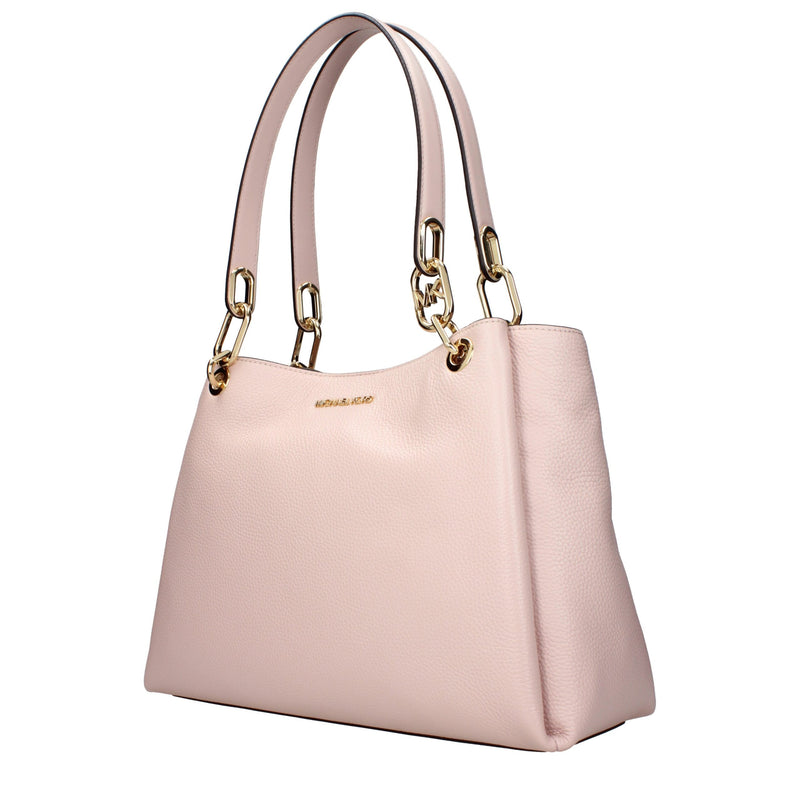 Light pink leather shoulder bag with gold chain accents on the double straps and subtle front logo lettering