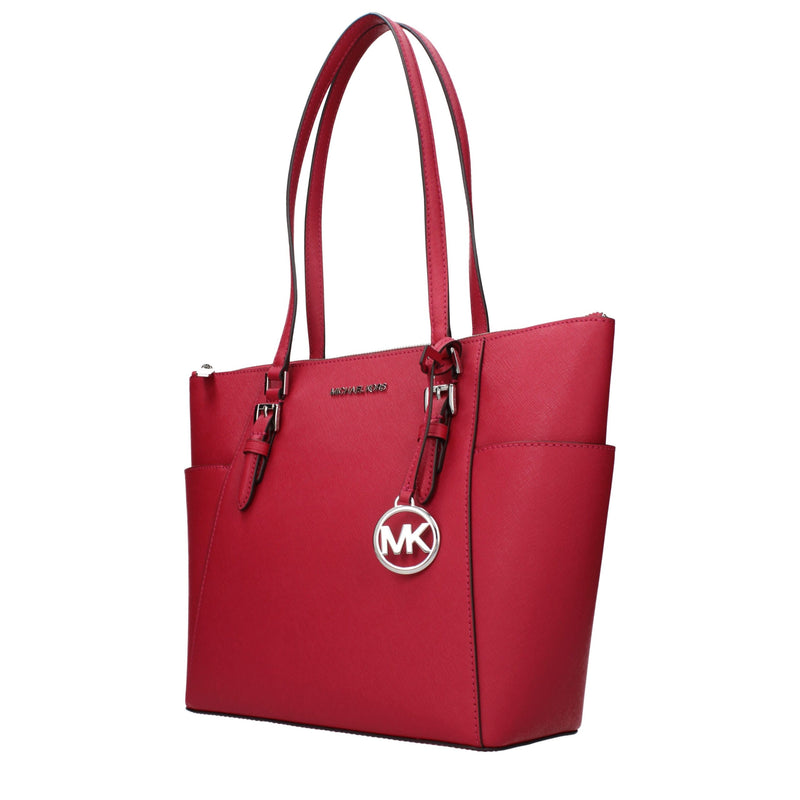 Bright red leather Michael Kors tote bag with dual shoulder straps and a hanging silver MK logo charm
