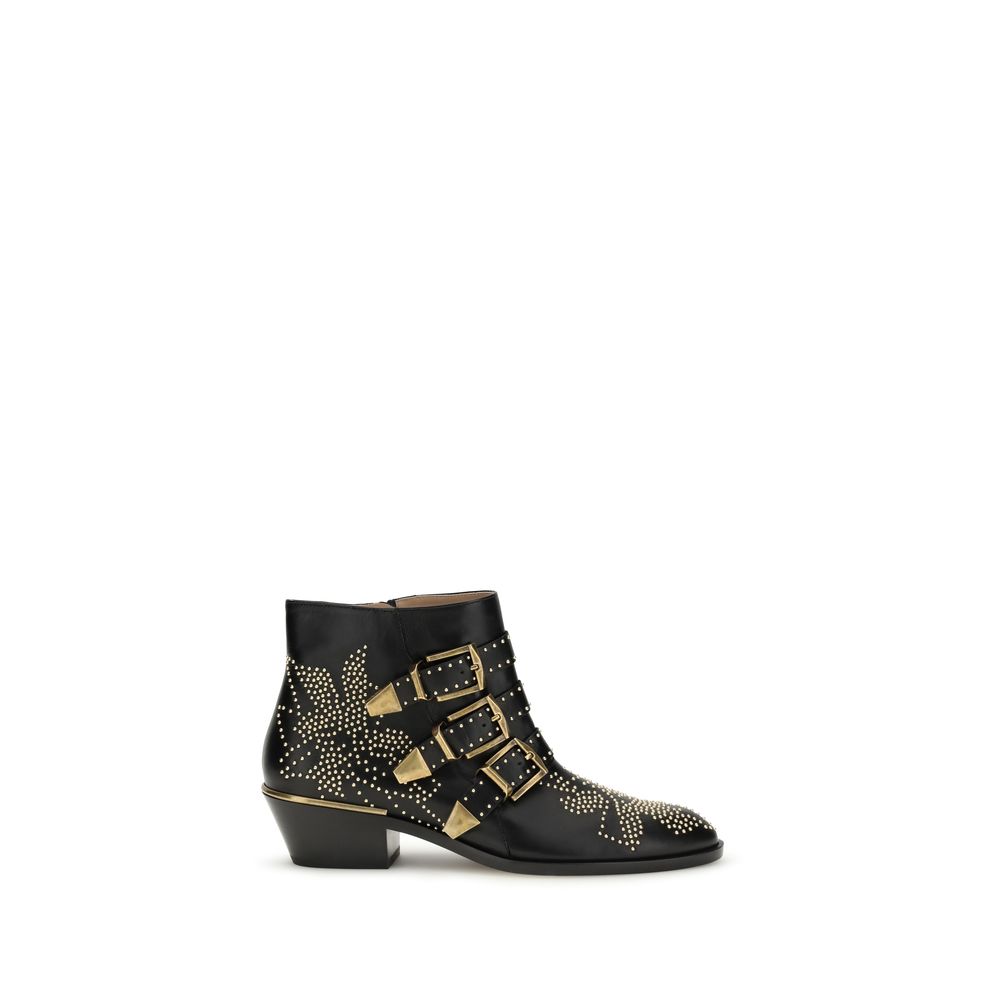 Black calf leather ankle boot with gold-tone buckle straps, stud detailing, and a stacked block heel.