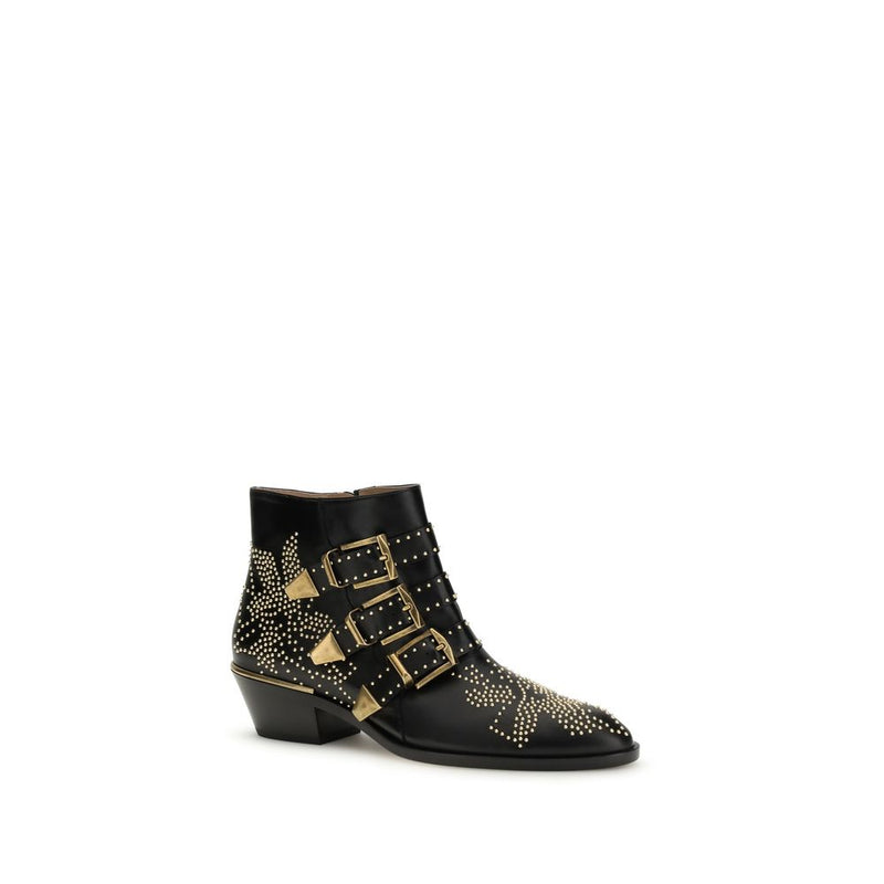 Chloé black calf leather ankle boots with gold-tone buckle straps, stud detailing, and a stacked heel.